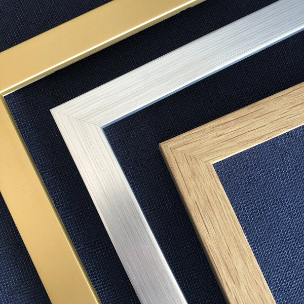 Close up image of 3 frame colour options - gold, silver and oak effect